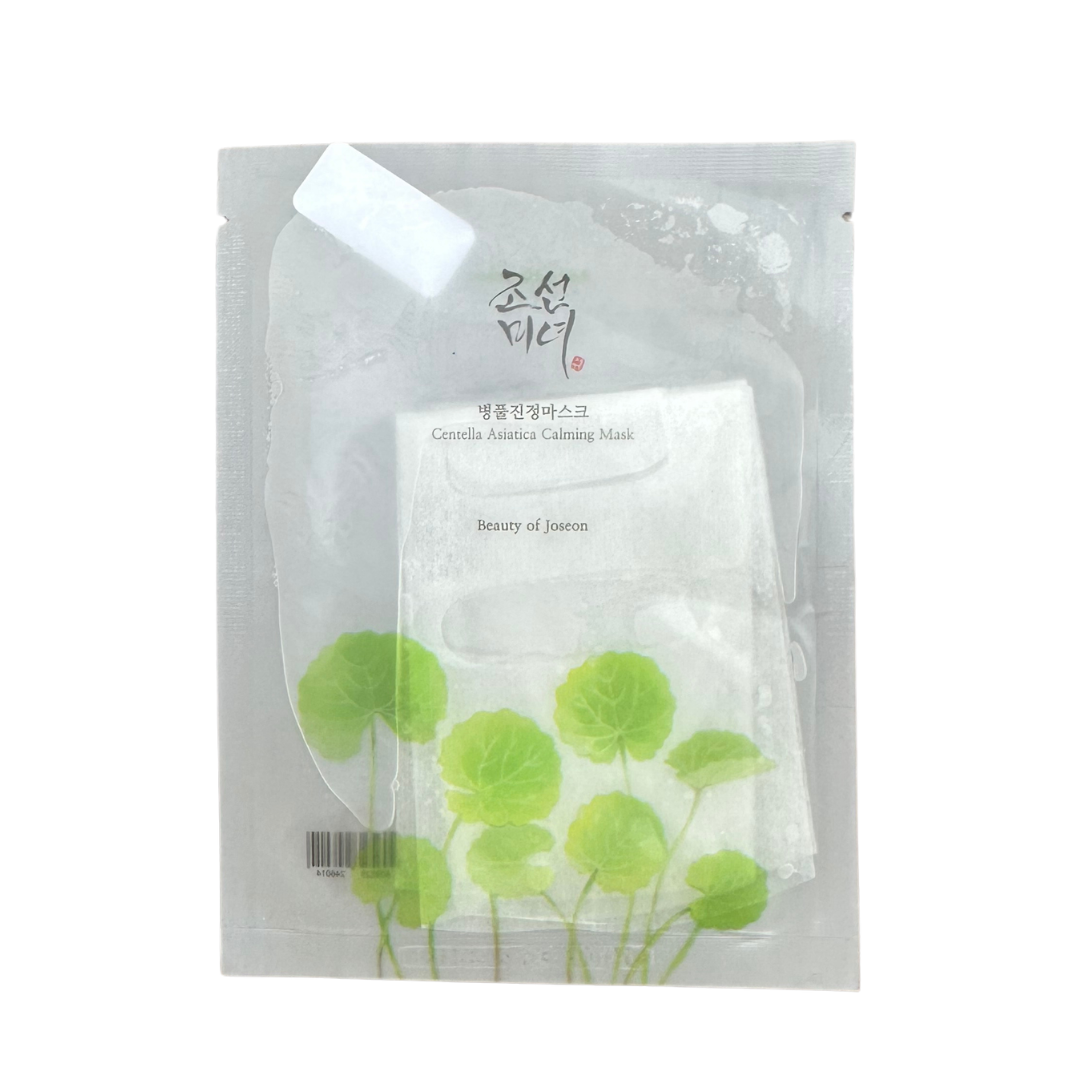 A single-use sheet mask in its clear plastic packaging, featuring green Centella Asiatica leaf illustrations and Korean text with the English name 'Centella Asiatica Calming Mask' and 'Beauty of Joseon'.