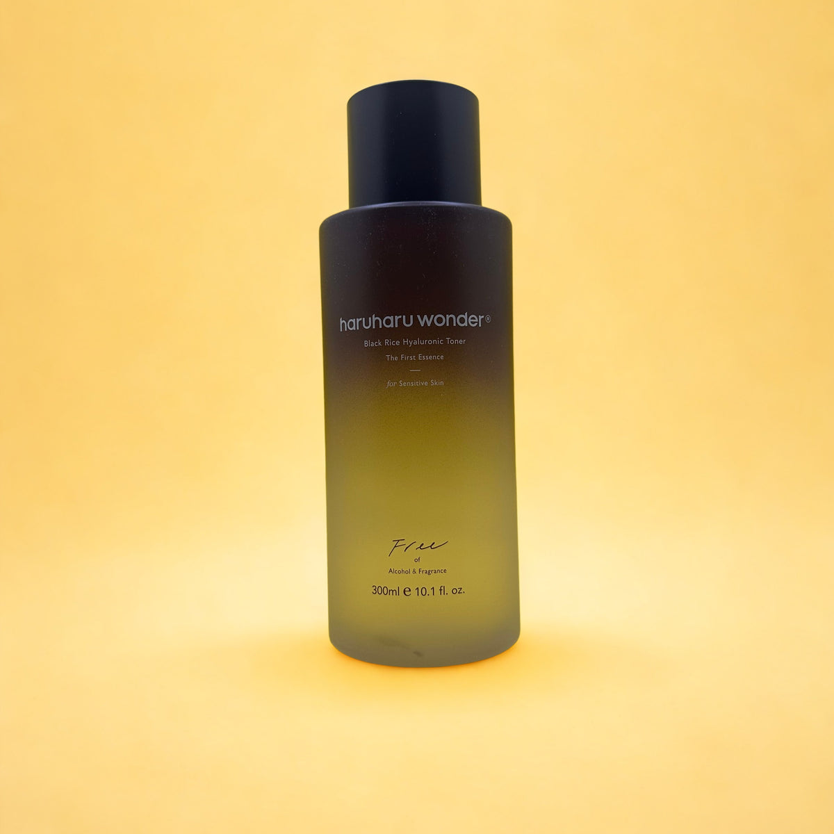 A 300ml bottle of haruharu wonder Black Rice Toner on a solid yellow background.