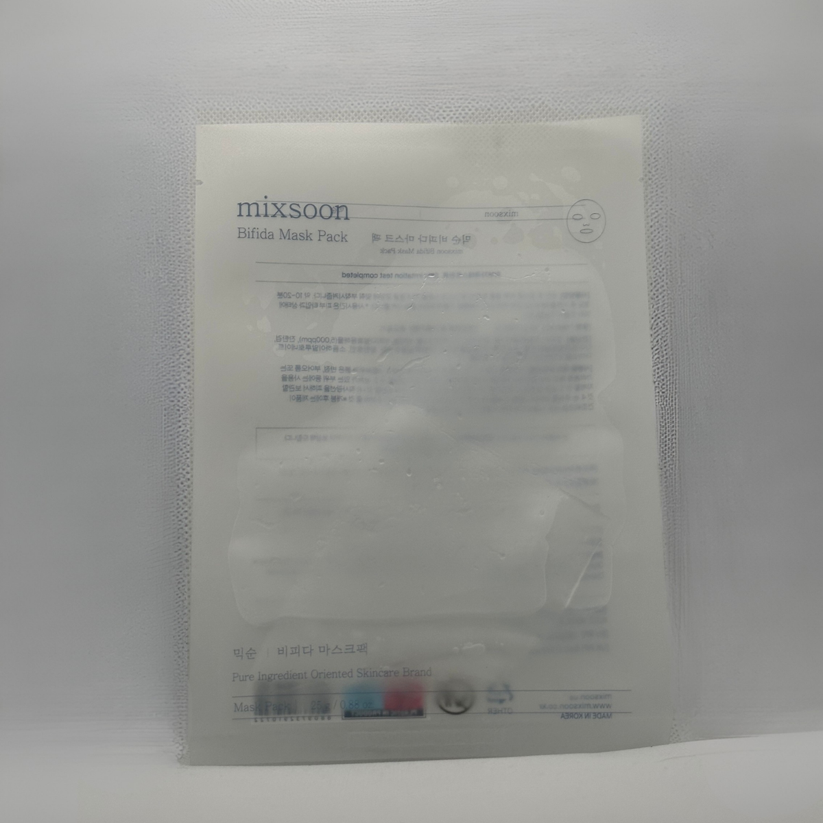 A sealed translucent pouch containing a Mixsoon Bifida Mask 25ml, photographed against a plain light gray background.