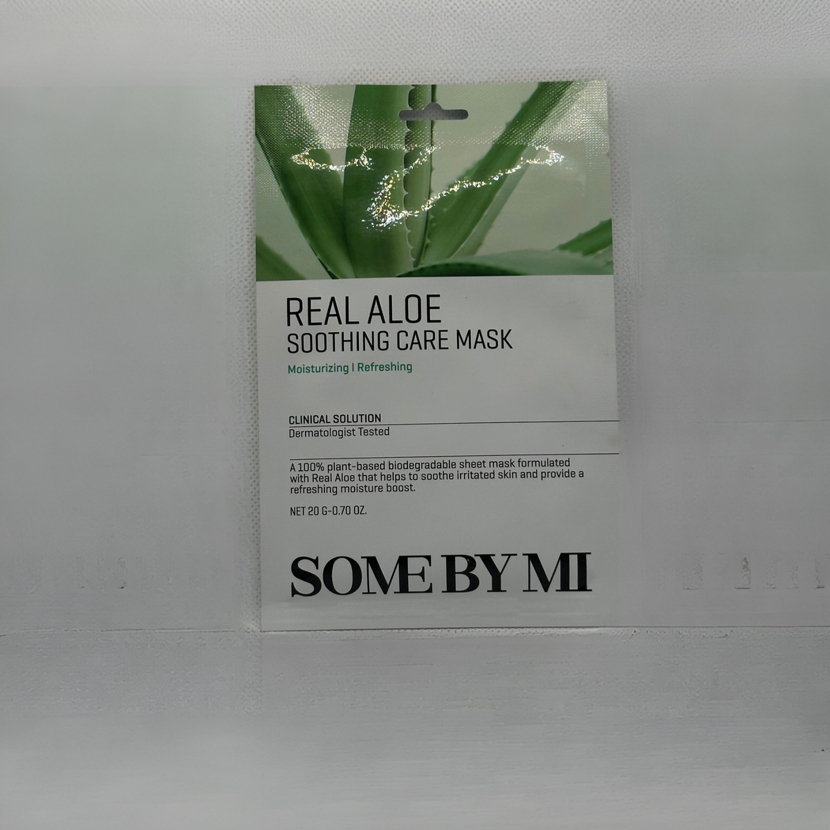 A single packet of SOME BY MI Real Aloe Soothing Care Mask, featuring a white and green design with aloe vera imagery, set against a plain light gray background.