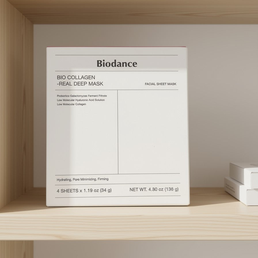 A white square box of Biodance Bio Collagen Real Deep Mask facial sheet mask, displayed on a light wood shelf against a neutral wall.